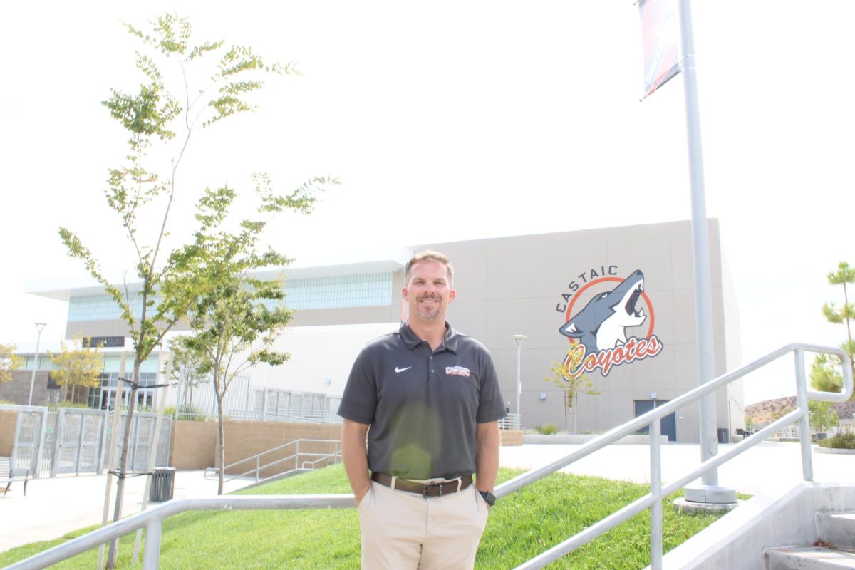 Mr. Wobrock standing in front of the newly painted Castaic Coyotes mural.