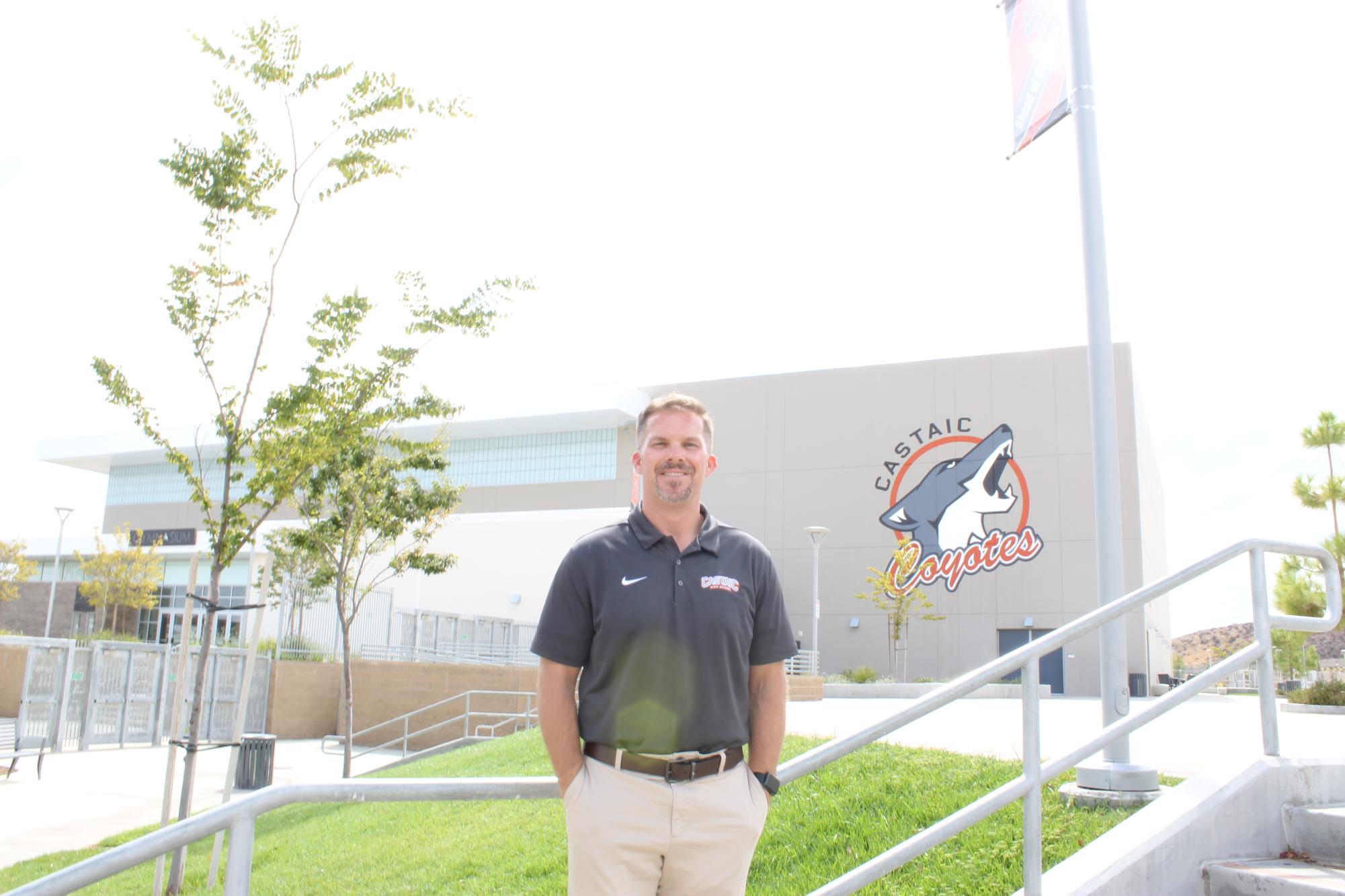 Mr. Wobrock standing in front of the newly painted Castaic Coyotes mural.